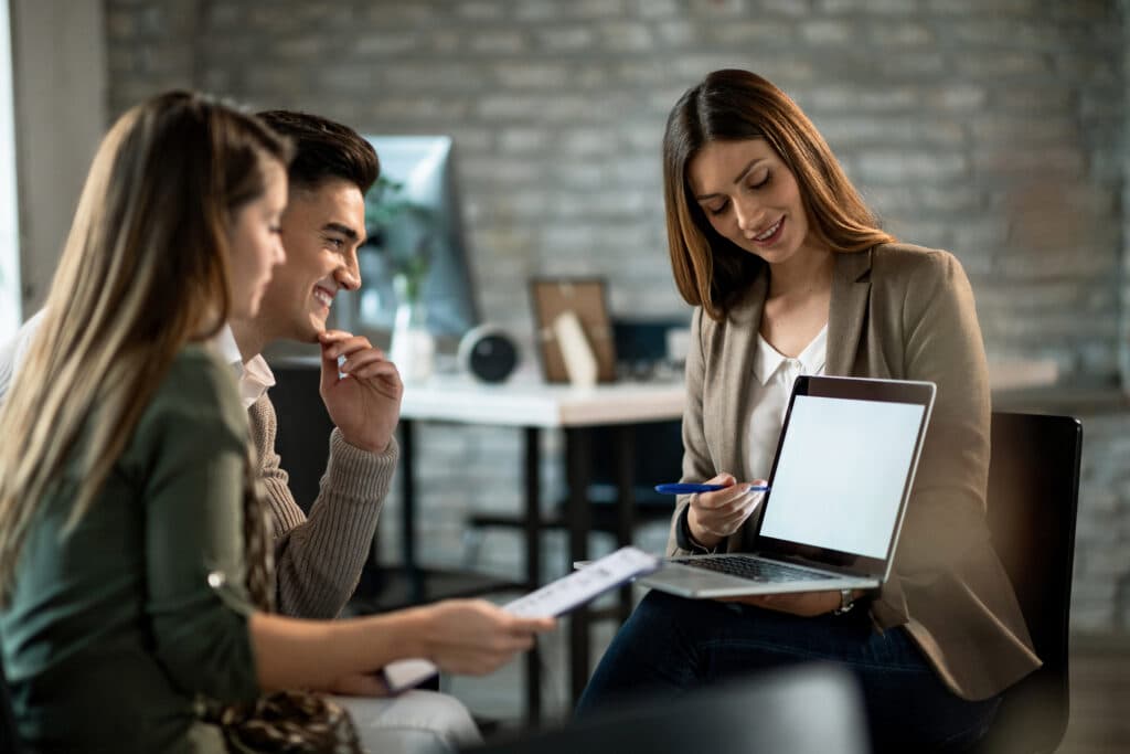A provider meeting with two parents at a table to talk through a support plan