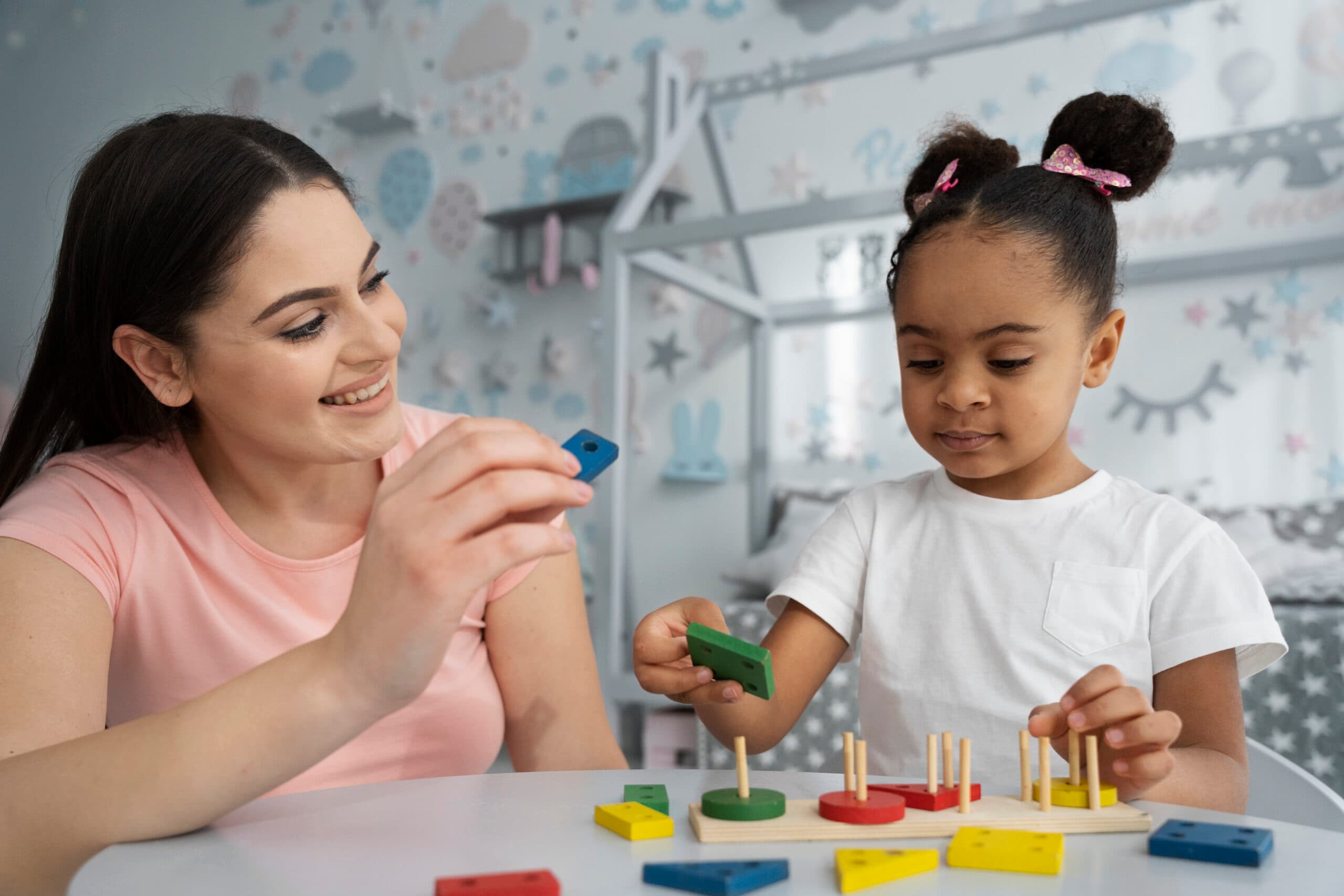 Close-up of a child concentrating on a hands-on learning game during a therapy session